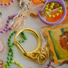 Collection of colorful keychains with various designs on a white background