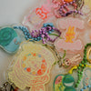 Collection of colorful keychains and charms on a white background